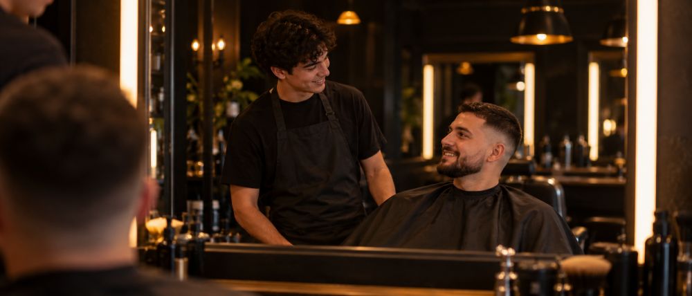 Barber student talking with a client